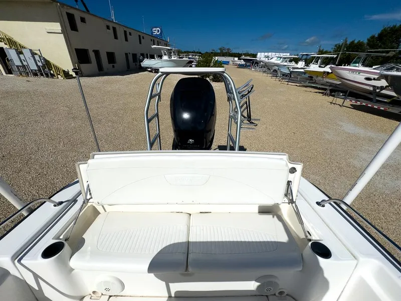 Slide: The Image of 2007 Boston Whaler 220 Dauntless boat with outboard motor in a boatyard. - 13