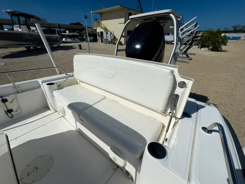 Slide: The Image of 2007 Boston Whaler 220 Dauntless boat with white seating and outboard motor. - 14