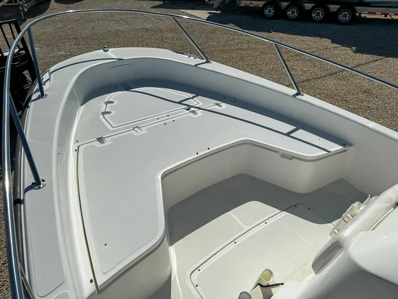 Slide: The Image of 2007 Boston Whaler 220 Dauntless boat deck with storage compartments and railings. - 19