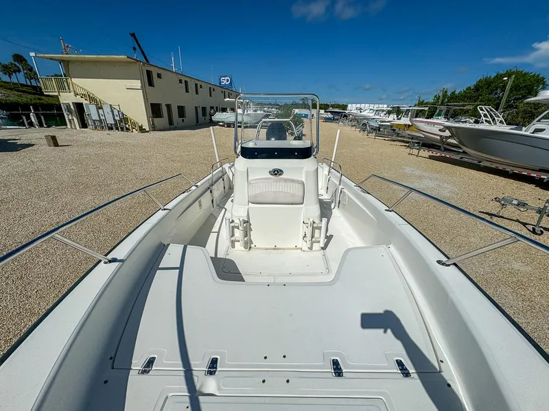 Slide: The Image of 2007 Boston Whaler 220 Dauntless boat on display in a sunny outdoor showroom. - 20