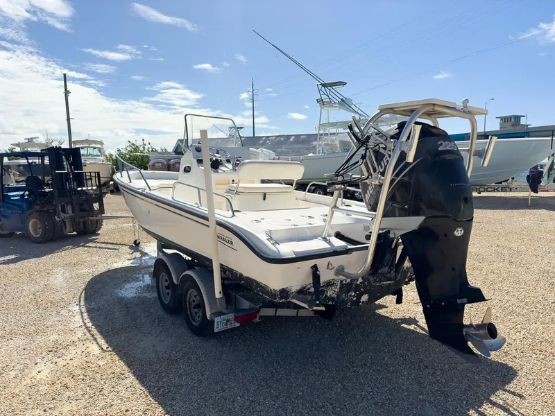Slide: The Image of 2007 Boston Whaler 220 Dauntless boat on a trailer in a sunny outdoor setting. - 5