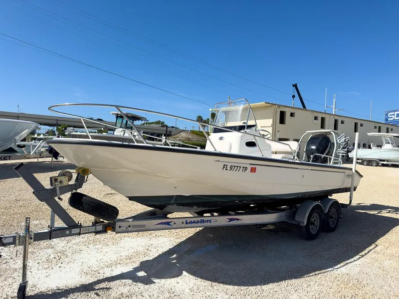 Slide: The Image of 2007 Boston Whaler 220 Dauntless boat on a trailer in a marina. - 7