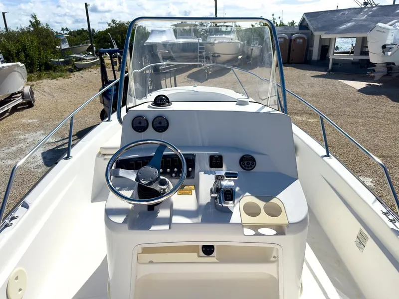 Slide: The Image of 2007 Boston Whaler 220 Dauntless boat console with steering wheel and controls. - 9