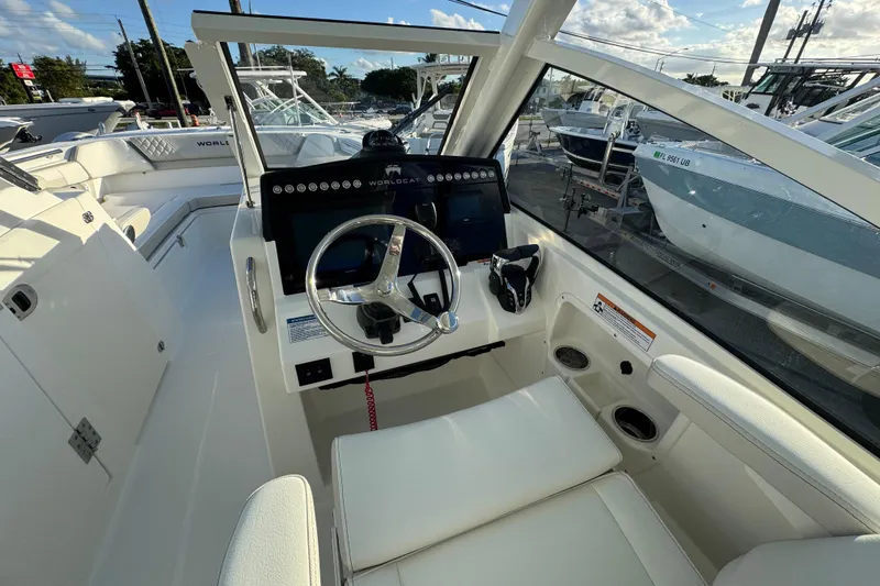 Slide: The Image of Interior view of 2026 World Cat 280 DC-X boat cockpit with steering wheel and controls. - 11