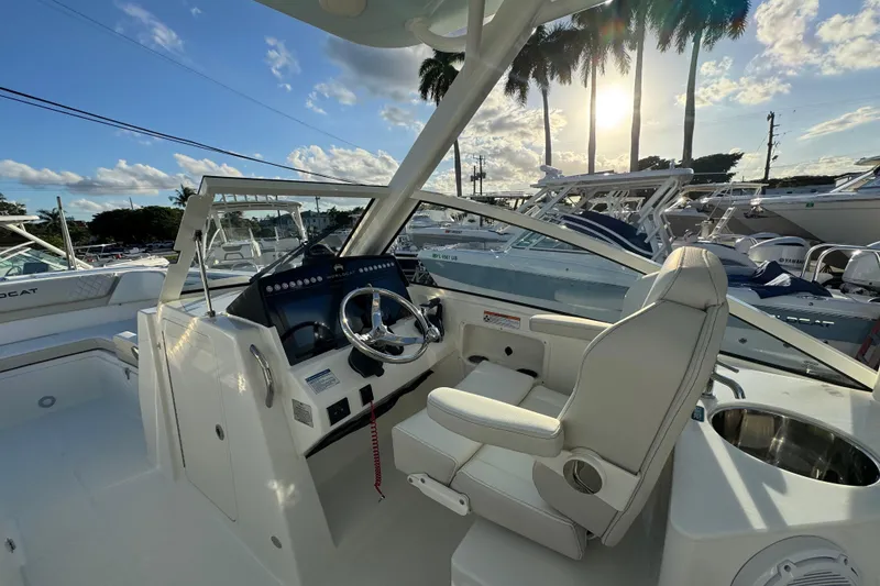 Slide: The Image of Helm of 2026 World Cat 280 DC-X boat with modern controls and seating. - 13