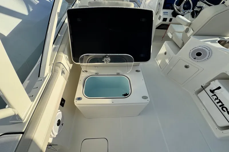 Slide: The Image of Interior view of 2026 World Cat 280 DC-X boat, featuring a storage compartment. - 16
