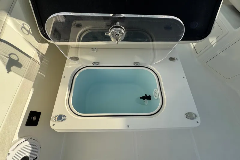 Slide: The Image of Livewell compartment on 2026 World Cat 280 DC-X boat, open lid view. - 18