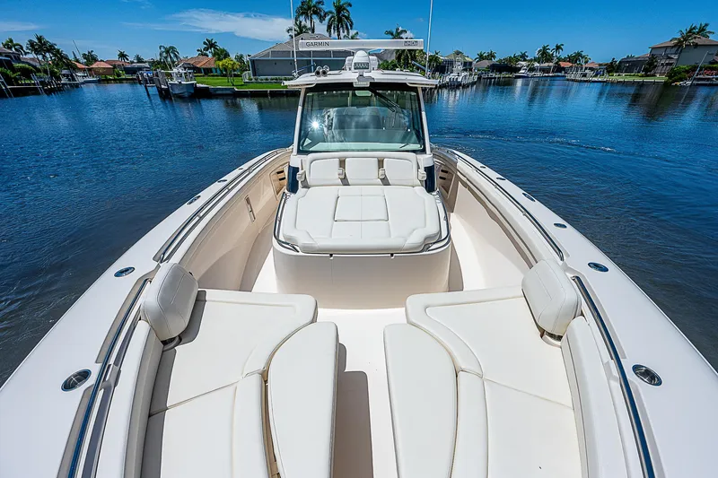 Slide: The Image of 2019 Grady-White Canyon 456 boat on a sunny day in a marina. - 11