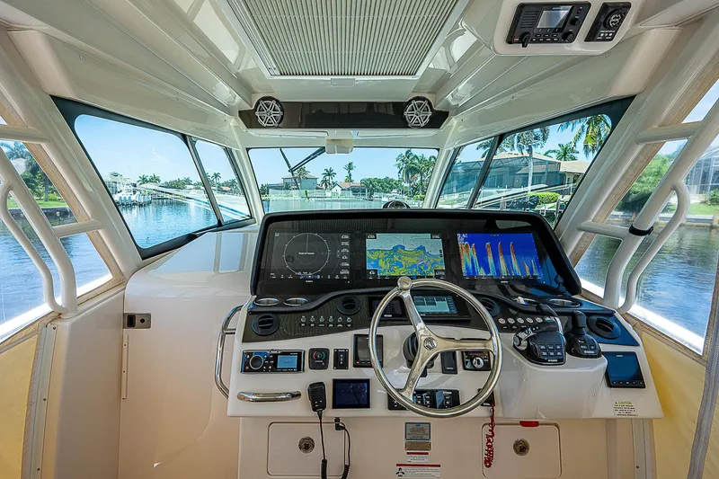 Slide: The Image of 2019 Grady-White Canyon 456 helm with advanced navigation system and waterfront view. - 23
