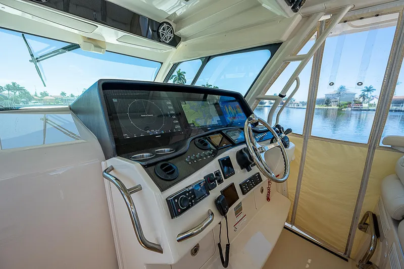 Slide: The Image of 2019 Grady-White Canyon 456 helm station with advanced navigation system and waterfront view. - 24
