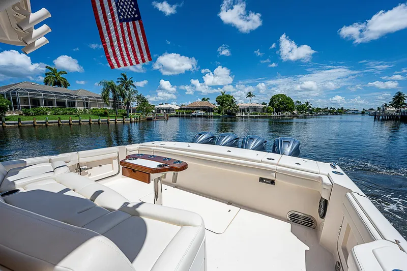 Slide: The Image of 2019 Grady-White Canyon 456 boat on a sunny day with American flag. - 28