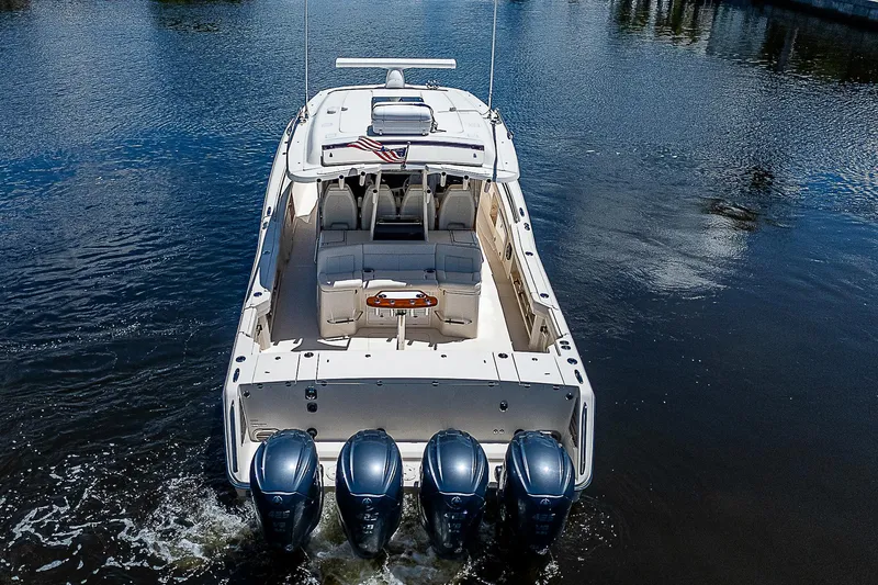 Slide: The Image of 2019 Grady-White Canyon 456 boat with four outboard engines on water. - 3