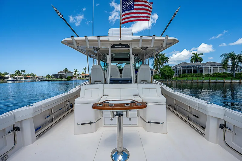 Slide: The Image of 2019 Grady-White Canyon 456 boat with luxurious seating and American flag. - 30