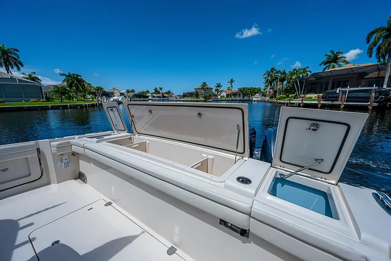Slide: The Image of 2019 Grady-White Canyon 456 boat with open storage compartments on a sunny day. - 33