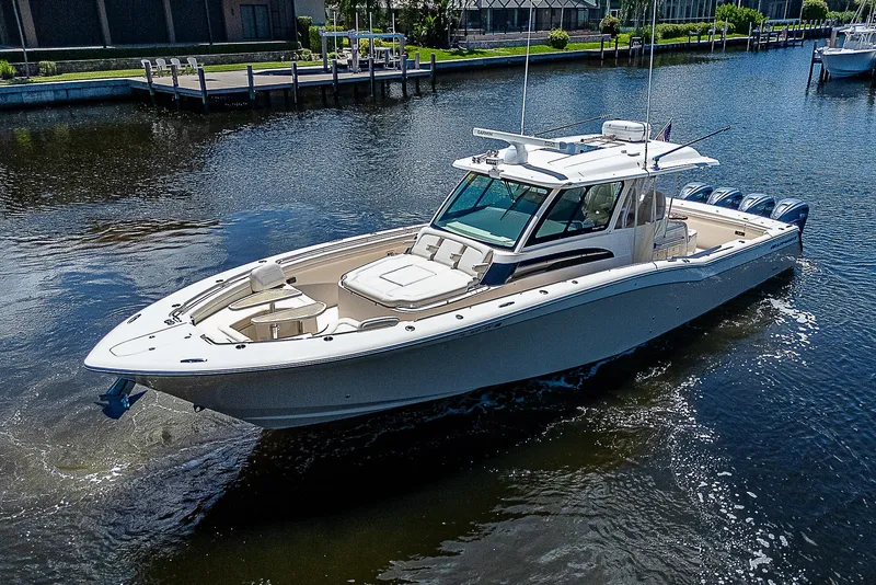 Slide: The Image of 2019 Grady-White Canyon 456 boat cruising on a calm river. - 4