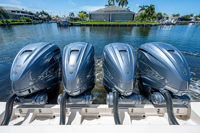 Slide: The Image of 2019 Grady-White Canyon 456 with four Yamaha outboard engines on a sunny day. - 44