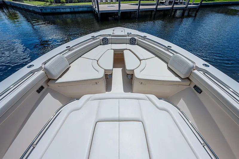 Slide: The Image of 2019 Grady-White Canyon 456 boat with spacious seating area on the water. - 9