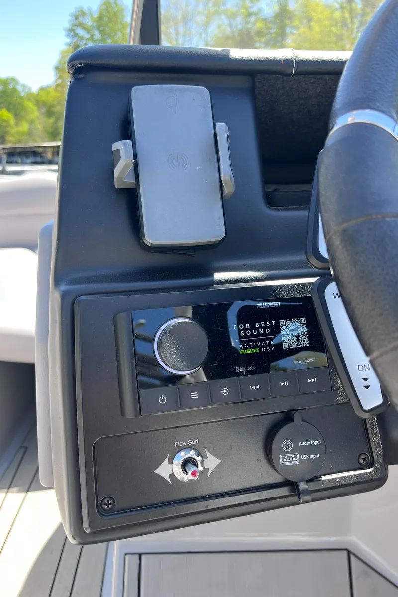 Slide: The Image of 2024 Moomba Max boat dashboard with control panel and phone holder. - 12