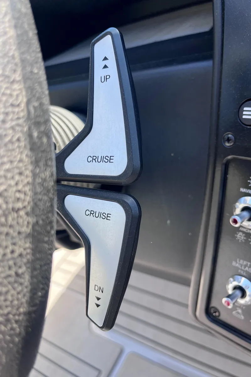 Slide: The Image of 2024 Moomba Max boat controls with cruise adjustment levers. - 14