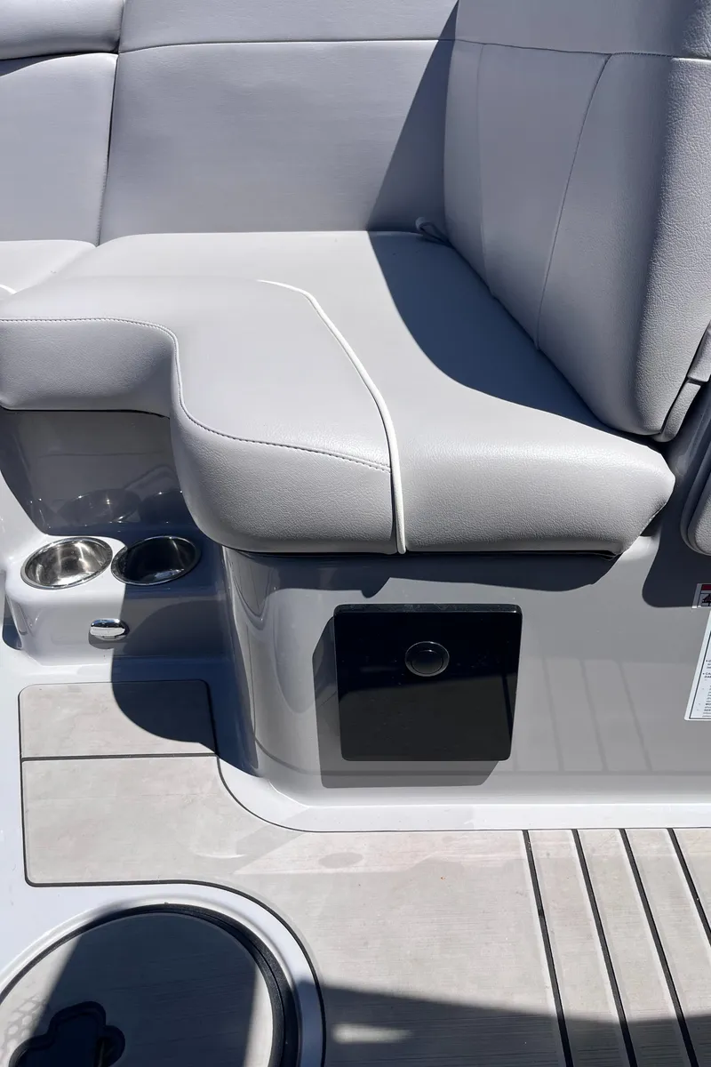 Slide: The Image of 2024 Moomba Max boat interior with gray seating and cup holders. - 19