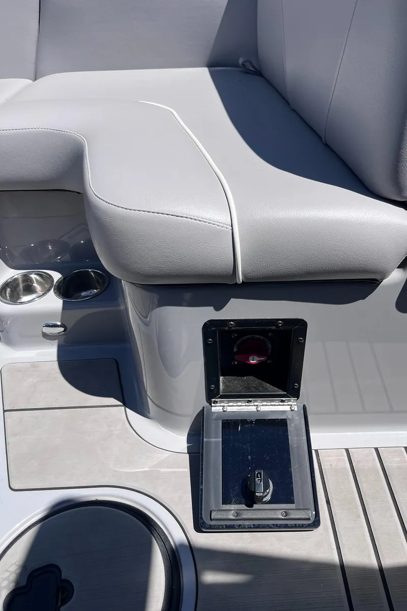 Slide: The Image of 2024 Moomba Max boat interior with gray seating and storage compartment. - 20
