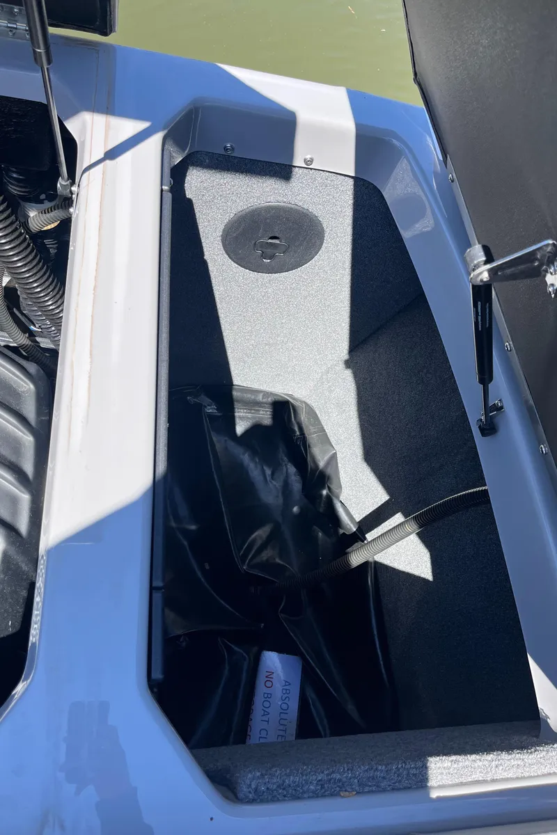 Slide: The Image of 2024 Moomba Max storage compartment with black interior and hydraulic lift. - 29