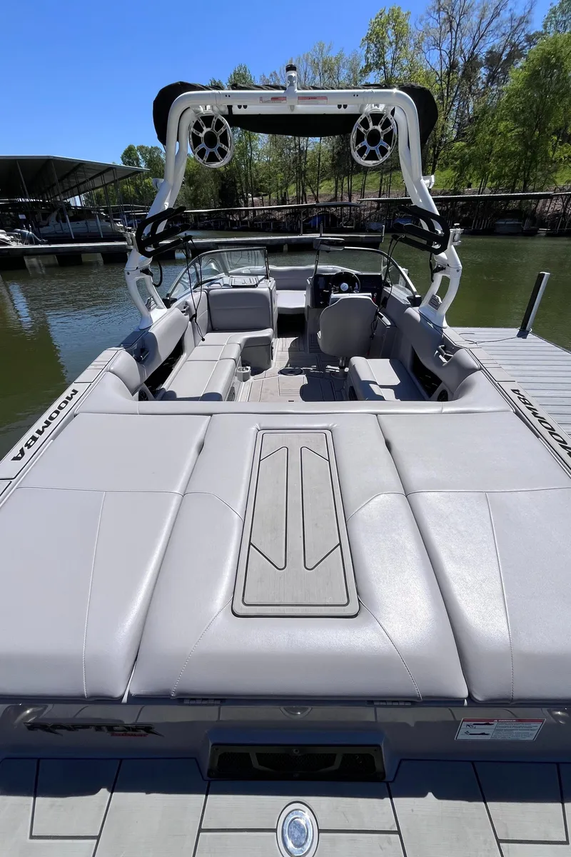 Slide: The Image of 2024 Moomba Max boat with sleek design, docked on a sunny day. - 3