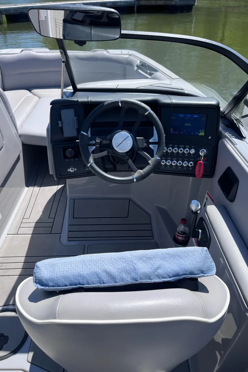 Slide: The Image of 2024 Moomba Max boat interior with steering wheel and dashboard controls. - 9