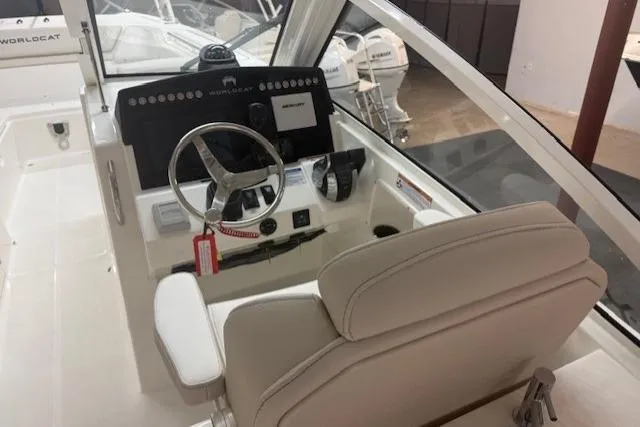 Slide: The Image of Helm of 2026 World Cat 280 DC-X boat with modern controls and steering wheel. - 3