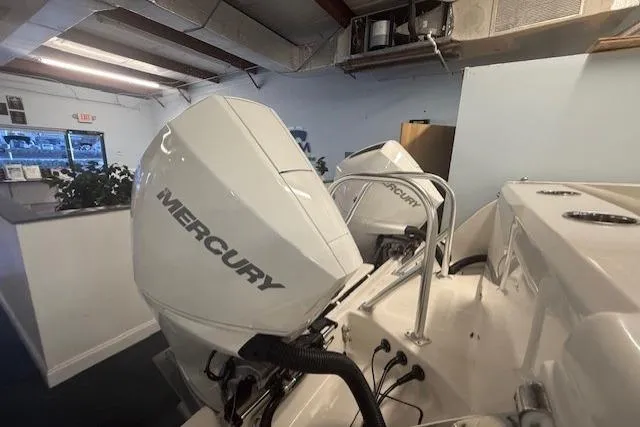 Slide: The Image of 2026 World Cat 280 DC-X with dual Mercury outboard engines in showroom. - 5