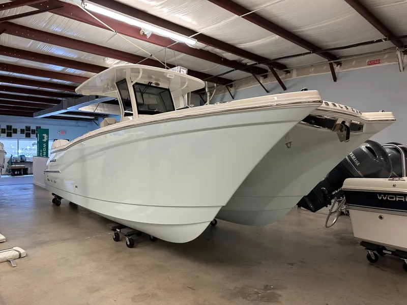 The Image of 2025 World Cat 280 CCX boat in a warehouse, showcasing sleek design and modern features. - 0