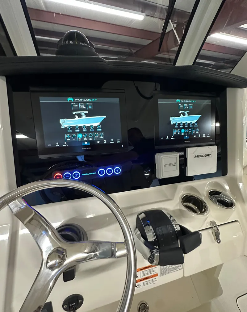 Slide: The Image of 2025 World Cat 280 CCX boat dashboard with dual touchscreen displays and steering wheel. - 5