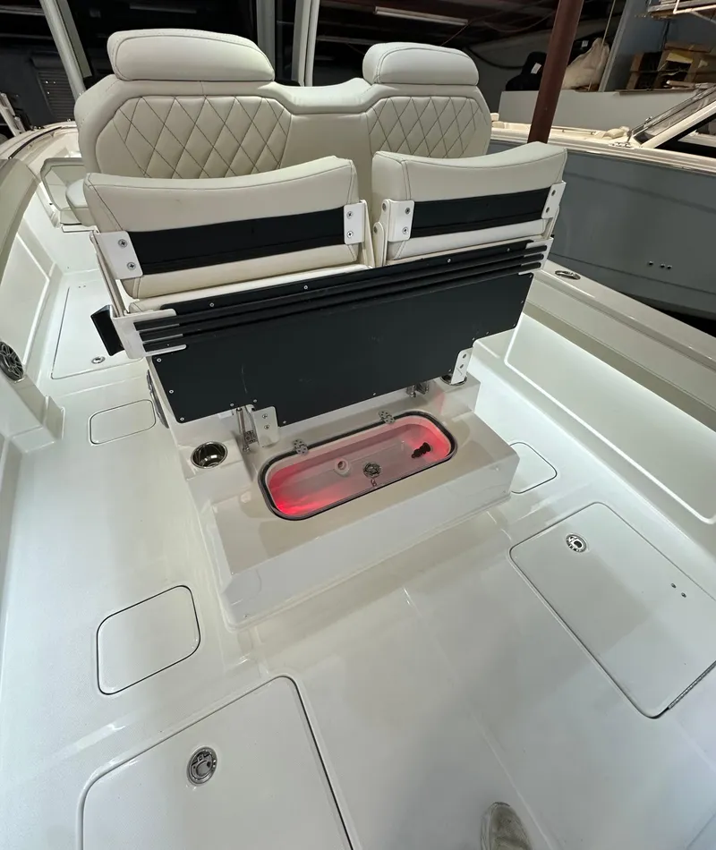 Slide: The Image of 2025 World Cat 280 CCX boat interior with luxurious seating and storage compartments. - 9