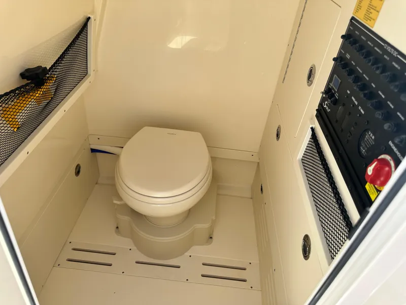 Slide: The Image of 2025 Scout 240 XSF boat interior with toilet and control panel - 13