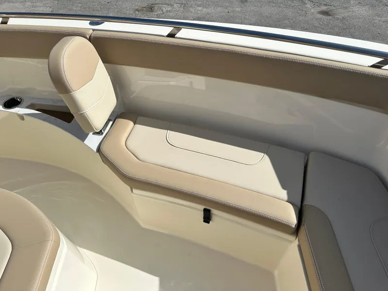 Slide: The Image of 2025 Scout 240 XSF boat interior with beige seating and storage compartments. - 18