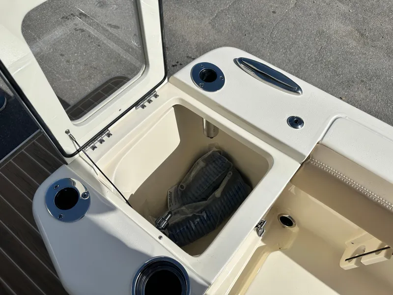 Slide: The Image of Open storage compartment on a 2025 Scout 240 XSF boat. - 6