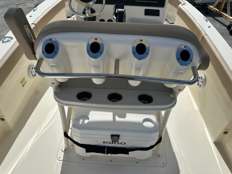 Slide: The Image of 2025 Scout 240 XSF boat interior with rod holders and Igloo cooler. - 8