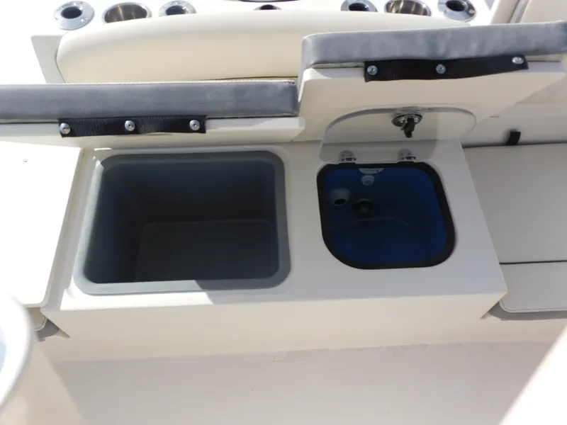 Slide: The Image of 2024 Stingray 216 CC boat storage compartments and sink. - 13