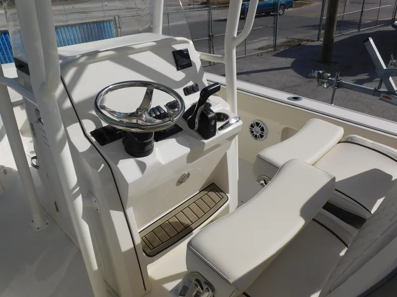 Slide: The Image of 2024 Stingray 216 CC boat console with steering wheel and seating. - 14