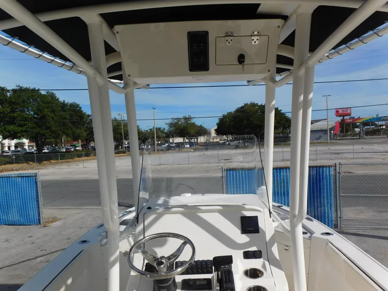 Slide: The Image of 2024 Stingray 216 CC boat interior with steering wheel and control panel. - 15