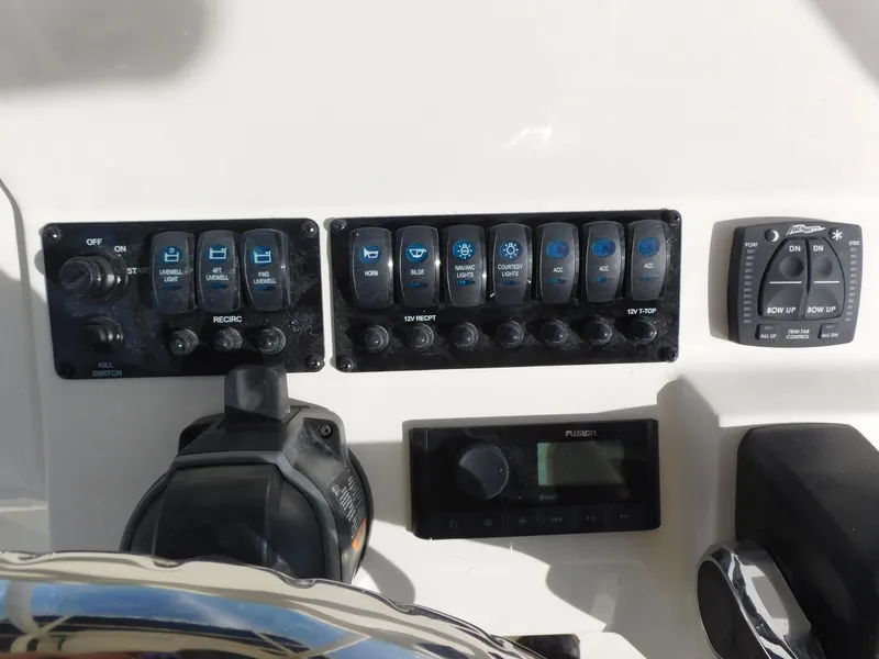 Slide: The Image of Control panel of a 2024 Stingray 216 CC boat with various switches and gauges. - 17