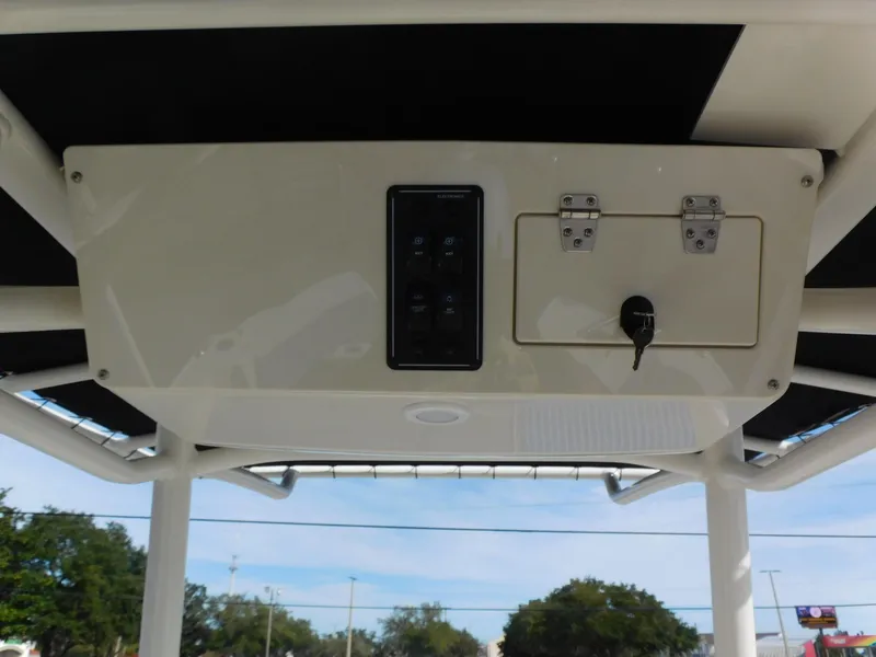 Slide: The Image of 2024 Stingray 216 CC boat console with control panel and storage compartment. - 19