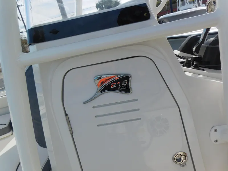 Slide: The Image of 2024 Stingray 216 CC boat console with logo and storage compartment. - 22