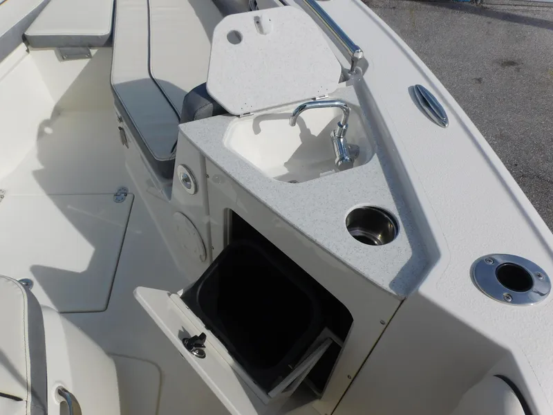 Slide: The Image of 2024 Stingray 216 CC boat interior with sink and seating area. - 25