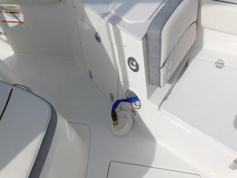 Slide: The Image of 2024 Stingray 216 CC boat interior with seating and storage compartments. - 32