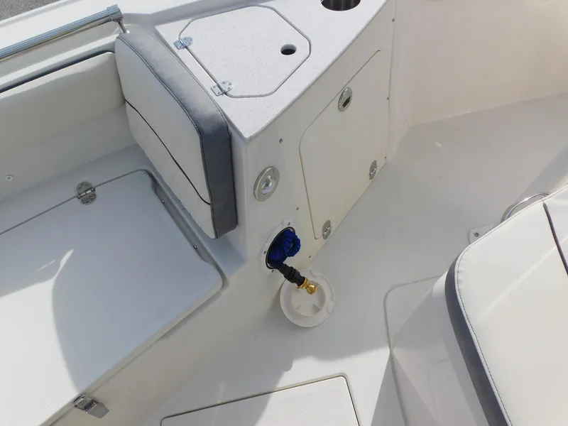 Slide: The Image of 2024 Stingray 216 CC boat interior, featuring seating and storage compartments. - 33