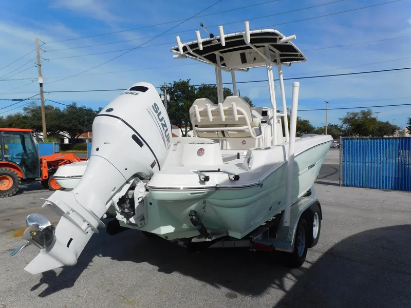 Slide: The Image of 2024 Stingray 216 CC boat with Suzuki outboard motor on a trailer. - 5