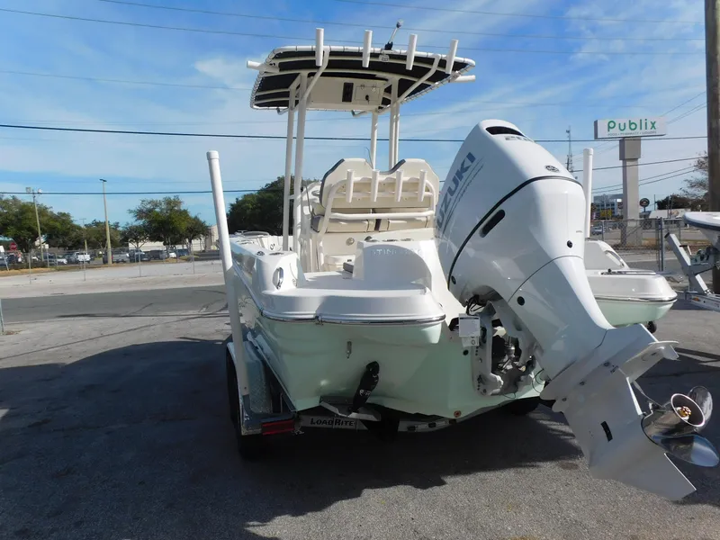 Slide: The Image of 2024 Stingray 216 CC boat with Suzuki outboard motor in parking lot. - 6