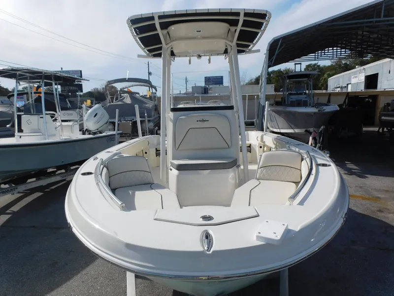 Slide: The Image of 2024 Stingray 216 CC center console boat in a marina. - 7