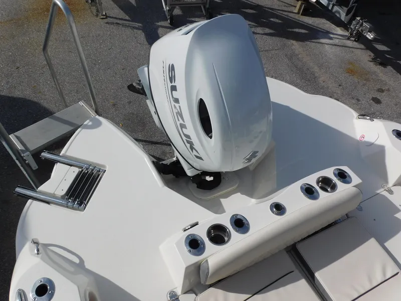 Slide: The Image of 2024 Stingray 216 CC boat with Suzuki outboard motor and fishing rod holders. - 9